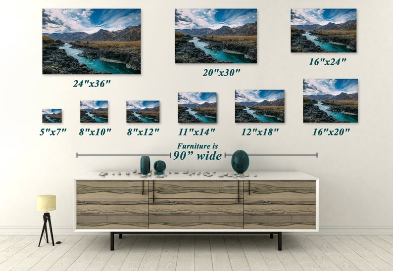 May include: Various sizes of landscape art prints featuring a turquoise river winding through a rocky canyon under a blue sky with clouds. Sizes range from 5"x7" to 24"x36". The furniture below is 90 inches wide.