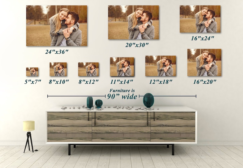 May include: A collection of canvas prints featuring a couple embracing, available in various sizes from 5"x7" to 24"x36". The prints are displayed on a white wall above a 90" wide cabinet. The image shows a warm, sepia-toned photograph.