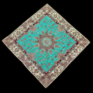 May include: A square turquoise and burgundy patterned throw pillow with a floral design. The pillow has a gold border with a paisley pattern.