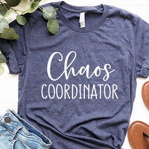 May include: A navy blue t-shirt with the text "Chaos Coordinator" in white lettering.