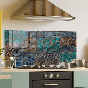 May include: A patterned kitchen splashback composed of square tiles in teal, brown, and blue. The tiles display intricate, swirling designs and textures. The splashback is positioned above a hob and oven, enhancing the kitchen's aesthetic.