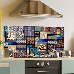 May include: A patterned kitchen splashback with a patchwork design. It features animal prints, geometric shapes, and floral motifs in a mix of blues, browns, and yellows. The splashback is mounted above a cooker.