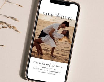 May include: Save the Date card with a photo of a couple on a beach. The text reads "Save the Date" and "Camilla and Damian are getting married! 15.09.2022 - New York, NY. Formal invitation to follow."