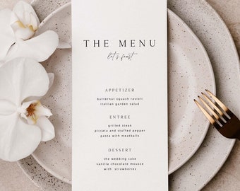 May include: A white menu card with the words "THE MENU" and "let's feast" in black text. The menu lists the following items: butternut squash ravioli, Italian garden salad, grilled steak, piccata and stuffed pepper pasta with meatballs, the wedding cake, vanilla chocolate mousse with strawberries.