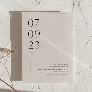 May include: A minimalist wedding save the date card with the date 07 09 23, the names Olivia and Chris, and the text "are getting married on Saturday, 5th September, 20XX, Santa Monica, CA. Formal invitation to follow."