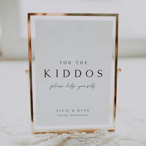 May include: A gold-framed sign with the text "FOR THE KIDDOS please help yourself" and "ELLIE & RYAN Saturday 19th September".