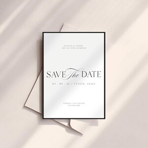 May include: A formal wedding invitation with a black border. The text "SAVE the DATE" is prominently displayed, along with the names "HANNAH & TOMMY" and the wedding date and location: "03.09.26 / VENICE. ITALY". The invitation is on a light background.