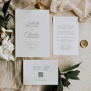 May include: Elegant wedding invitation suite with calligraphy text. The main card features the names "Juliette Williams & Charles Johnson." Additional cards include event details and a reply card with a QR code. The suite is on a neutral background.