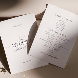 May include: Two white wedding programs with elegant black text. One program reads "Welcome to The Wedding Juliette & Charlie" and "Venice, Italy." The other lists the order of events and wedding party details.