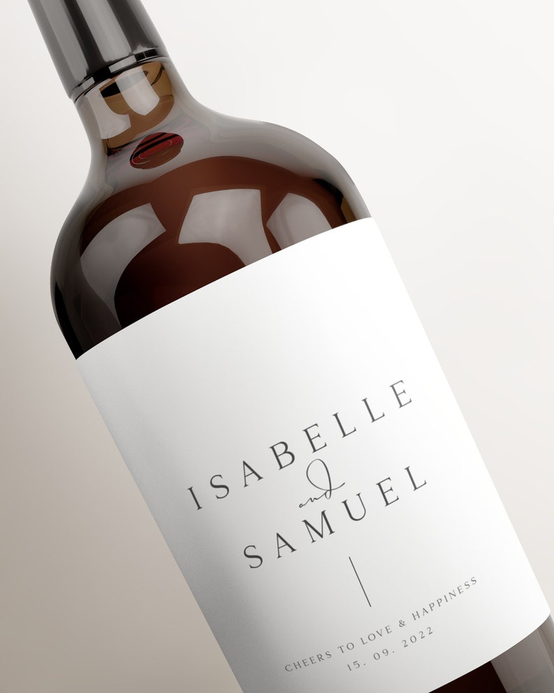 May include: A white wine bottle label with the text "Isabelle and Samuel" and "Cheers to love & happiness 15.09.2022".