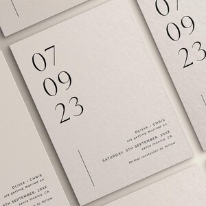 May include: A minimalist wedding invitation with the date "07 09 23" printed in black on a white background. The text "OLIVIA + CHRIS are getting married on SATURDAY, 5TH SEPTEMBER, 20XX santa monica, CA formal invitation to follow" is printed in black at the bottom of the invitation.