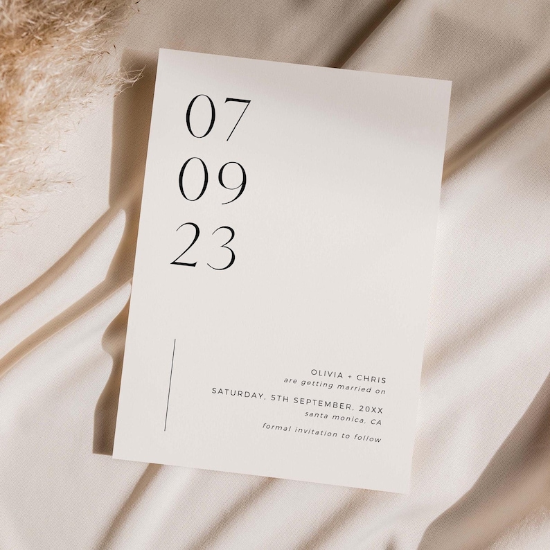 May include: A simple white wedding save the date card with black text. The date is 07 09 23. The text reads "Olivia + Chris are getting married on Saturday, 5th September. 20XX Santa Monica, CA Formal invitation to follow."