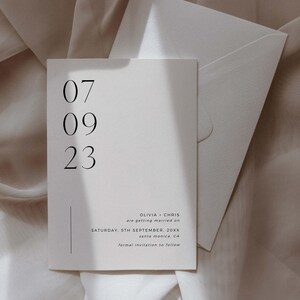 May include: A simple wedding save the date card with a white background and black text. The date is 07 09 23. The text reads "Olivia + Chris are getting married on Saturday, 5th September, 20XX Santa Monica, CA Formal invitation to follow."