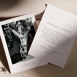 May include: Wedding thank you cards featuring a black and white photo of a champagne tower. The card on the left says "Thank You" in script. The card on the right has text that reads "Dear Family and Friends" and a message from Juliette & Charles.
