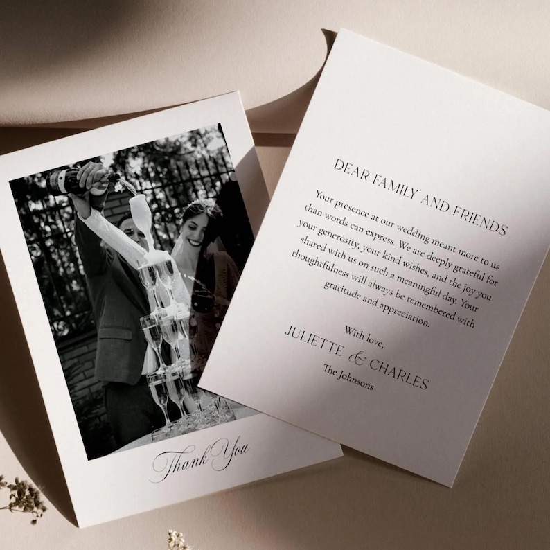May include: Wedding thank you cards featuring a black and white photo of a champagne tower. The card on the left says "Thank You" in script. The card on the right has text that reads "Dear Family and Friends" and a message from Juliette & Charles.