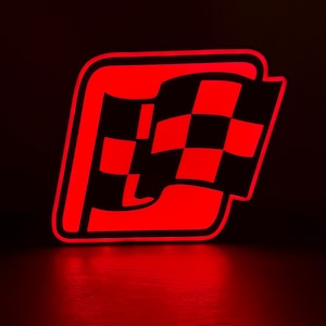 May include: A glowing red checkered flag logo, outlined in red, against a dark background. The flag is black and red, with a rectangular shape. The image is illuminated with a red glow.