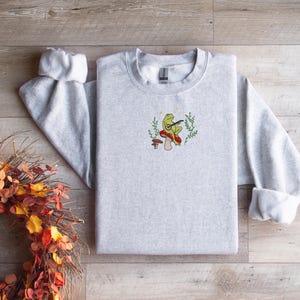 Vintage Frog Cottagecore Frog Sweatshirt, Whimsical Forest Aesthetic Crewneck with Frog on Mushroom, Nature-Inspired Embroidered Sweatshirt