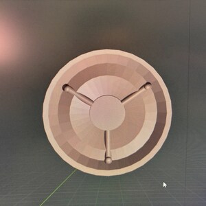 May include: A wooden circular base with three legs extending from the center. The base is light brown and has a smooth, polished finish.