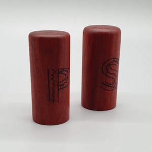 Salt and pepper shakers made from Padauk wood, each mill is hand turned on a lathe and is a unique one off piece of wood art.