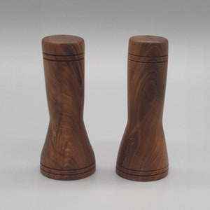Salt and pepper shakers made from Laburnum hardwood, each mill is hand turned on a lathe and is a unique one off piece of wood art.