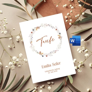 Könnte beinhalten: Eine weiße Karte mit einem floralen Kranzdesign und dem Wort "Taufe" in orangefarbener Schrift. Der Text "Emilia Seiler" befindet sich unter dem Kranz, gefolgt von "Erlöserkirche Amberg" und "22. Juni 2026".