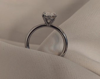 Classic Oval Lab-grown Diamond Engagement Ring on a gold band.