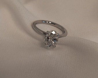 Elegant Classic Oval Natural Diamond Engagement Ring on a gold band.