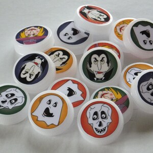May include: A set of 12 Halloween themed bottle caps featuring various spooky characters, including ghosts, vampires, and skeletons. The caps are white with colorful images and are perfect for adding a festive touch to your Halloween decorations.