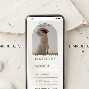 May include: A smartphone screen displaying a website with the text "Welcome!" and "Choose Your Adventure". The website has links to "Work With Me", "My Free Guide", "My Portfolio", and "Book a Session".