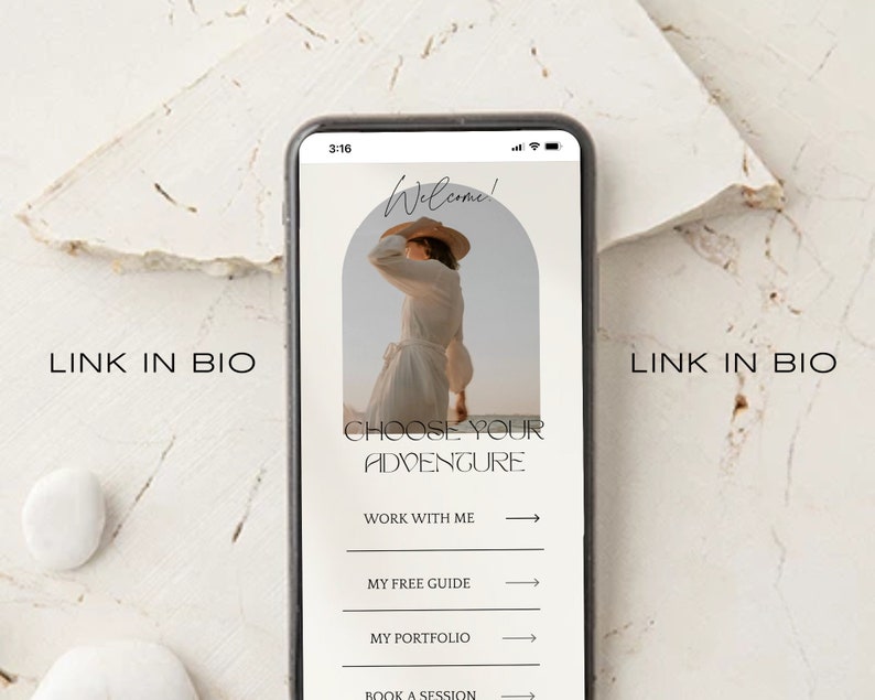 May include: A smartphone screen displaying a website with the text "Welcome!" and "Choose Your Adventure". The website has links to "Work With Me", "My Free Guide", "My Portfolio", and "Book a Session".
