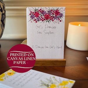 May include: A white card with a floral design and the text "God's Promises from Scripture" and "30 Promises from God's Word". The card is printed on canvas linen paper and is displayed on a wooden stand.