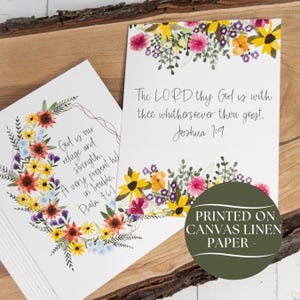 May include: Two white cards with floral watercolor designs. One card features a floral wreath with text: "God is our refuge and strength, A very present help in trouble. Psalm 46:1." The other card has text: "The LORD thy God is with thee whithersoever thou goest. Joshua 1:9."