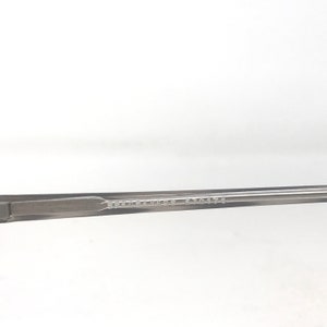May include: Close-up of a gray eyeglass frame arm. The text "SPECSAVERS 570474" is printed on the arm. The frame is a neutral color, suitable for various styles.