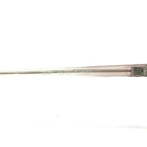 May include: Close-up of a transparent eyeglasses frame with the text "7049 55/18 C3502" printed on the arm. The frame is a light, neutral color, and the image is set against a white background.