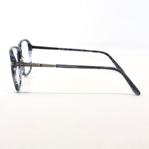 May include: Eyeglasses with a marbled grey and clear frame. The dark grey temples connect to the frame with a silver-coloured hinge. The clear lenses are set against a white background. The glasses are a classic style.