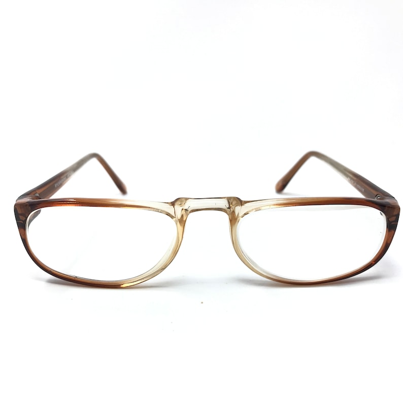 May include: Brown plastic framed eyeglasses with clear lenses.