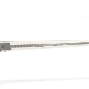May include: Close-up of a clear eyeglass frame arm with the text "SPECSAVERS 65 C155" printed in a light gray color. The frame arm is made of a transparent material and has a rectangular shape.