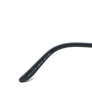 May include: Black eyeglasses arm with the text "53▢17-135 LUELLA 25177787" printed in white. The arm curves slightly and has a rounded tip.