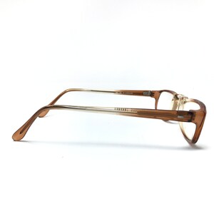 May include: Brown plastic framed eyeglasses with clear lenses. The frames have a gradient color, fading from a darker brown to a lighter brown.