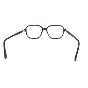 May include: Eyeglasses with a tortoiseshell pattern frame and rectangular lenses. The temples are dark brown and extend outward. The glasses are set against a white background.