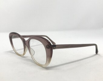 May include: A pair of pink and clear plastic cat-eye glasses with a silver accent on the side.