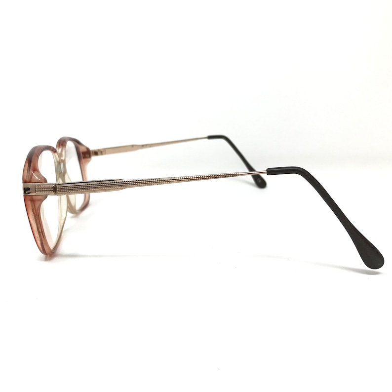 K&ouml;nnte beinhalten: Eine Brille mit braunem Kunststoffgestell, goldenen Metallb&uuml;geln und schwarzen Kunststoffb&uuml;gelenden.
