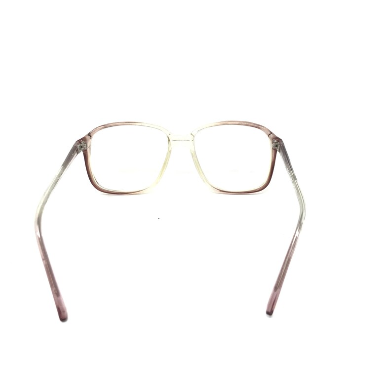 May include: Clear-framed eyeglasses with a rectangular shape. The frames transition from a light color to a darker shade of brown near the lenses. The temples are a light color that fades to a darker shade of brown.