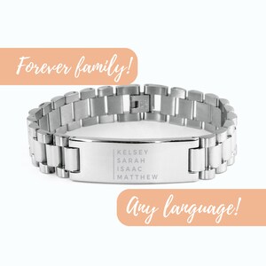 May include: A silver-toned bracelet with a rectangular nameplate engraved with the names Kelsey, Sarah, Isaac, and Matthew. The bracelet has a link design and the text "Forever family!" and "Any language!" are displayed.
