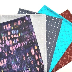 May include: A selection of fabric samples in diverse patterns and colours. The fabrics feature a dark blue with colourful abstract shapes, grey with white dots, navy with white dots, turquoise with a geometric design, and brown with a cross pattern.