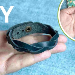 May include: DIY project: a dark blue leather bracelet with a braided design and a metal button closure.