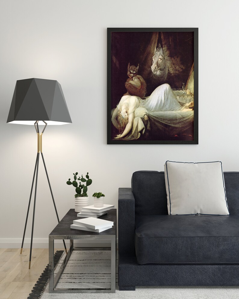 May include: A black framed print of a painting depicting a woman lying in bed with a demon and a horse's head hovering above her. The painting is set against a dark background.