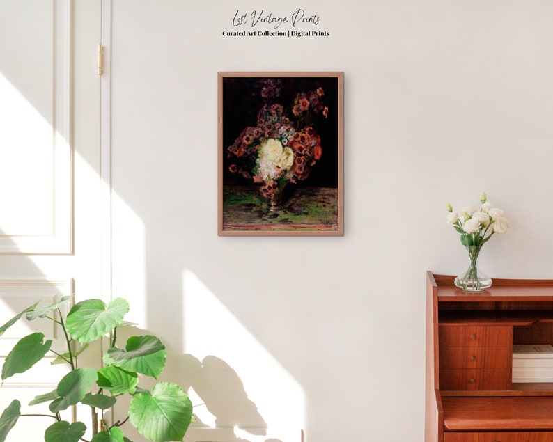 May include: A framed vintage painting of a still life featuring a bouquet of flowers in a glass vase. The flowers are a mix of white, pink, and red, and the vase is sitting on a table with a green tablecloth. The painting is set against a dark background.
