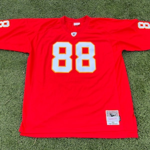 May include: A red football jersey with the number 88 in white with yellow trim on the front and sleeves. The jersey has the name "TONY GONZALEZ" on a tag at the bottom.