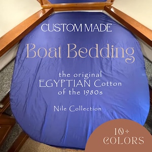 May include: A custom-made blue boat bedding sheet featuring the text CUSTOM MADE Boat Bedding the original EGYPTIAN Cotton of the 1980s Nile Collection and a brown circular graphic with the text 10+ COLORS.